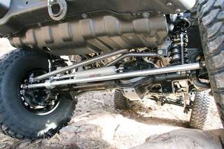Currie Enterprises’ Rock Jock 60 high pinion front and rearends need no introduction. Their JK-specific Rock Jocks arrive ready to install, complete with heavy Currie control arm bracketry, ABS/ESC tone rings and sensors, and everything needed for a painless, bolt-in installation. Hard Rock’s front Rock Jock 65-45-12 ductile iron housing center was built with Yukon 5.38 gears and an Eaton Detroit Locker. This Rock Jock came with Currie’s heavy-duty one-ton knuckles, G2 axleshafts, and Warn Premium hubs. Dakota Customs welded tabs on the Currie fabricated cover to mount the PSC steering ram. PSC supplied the aluminum clamp to attach the ram to Currie’s Chromoly tie rod. Synergy’s adjustable drag link was used.