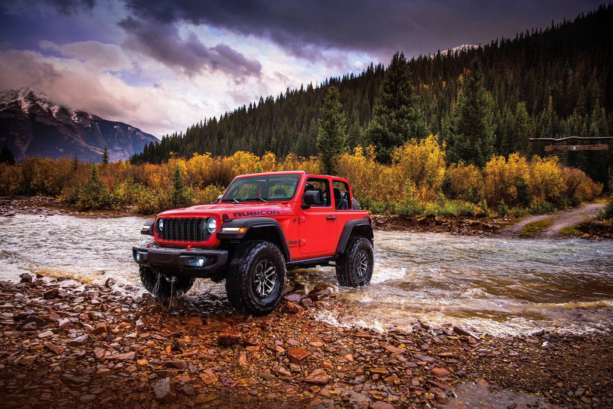 Red Jeep crossing a river
