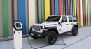 White Jeep Wrangler with a colorful background