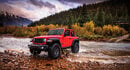 Red Jeep crossing a river