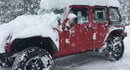Red Jeep with snow 