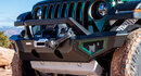 Front of a green Jeep grille with a winch