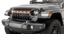 A Jeep Wrangler Willys shows off its TACTIK Goblin Grille with integrated amber accent lighting for a bold, custom front-end look.