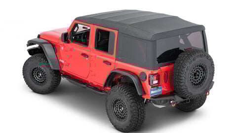 A red Jeep Wrangler on a white background with a black soft top.