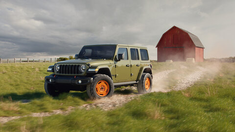 Green Jeep with a farm background
