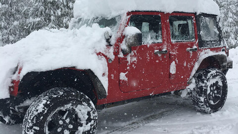 Red Jeep with snow 