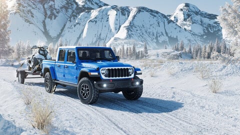 Blue Jeep Gladiator with a snowy background