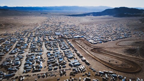 Vehicles and tents in the California desert