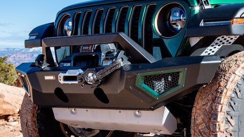 Front of a green Jeep grille with a winch