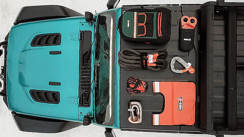 Jeep recovery gear in a blue Wrangler