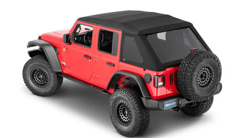 Red Jeep Wrangler with a black soft top against a white background