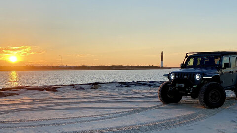 Jeep on the beach in the summer